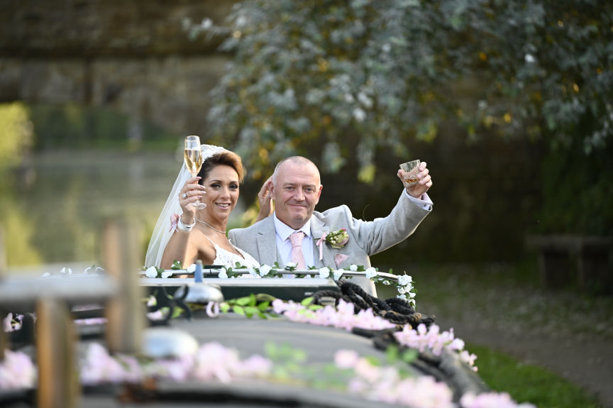 bride and groom on there wedding boat