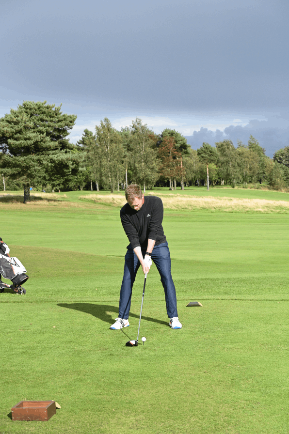 A man playing golf on a Corporate Golf day in stockport.