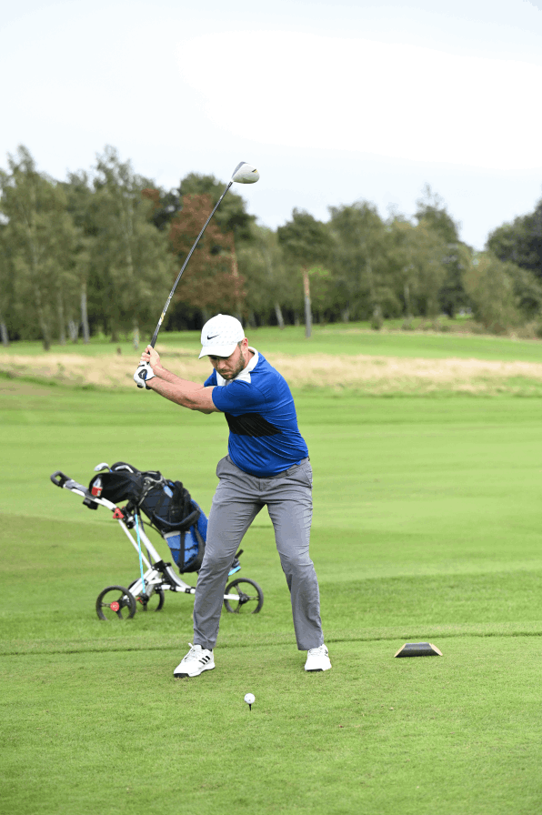 A man playing golf on a Corporate Golf day in stockport.