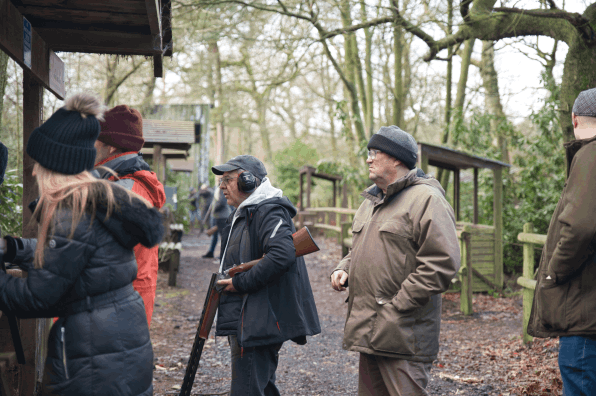 A male client having a go at clay pigeon shooting on a corporate day in Manchester   
